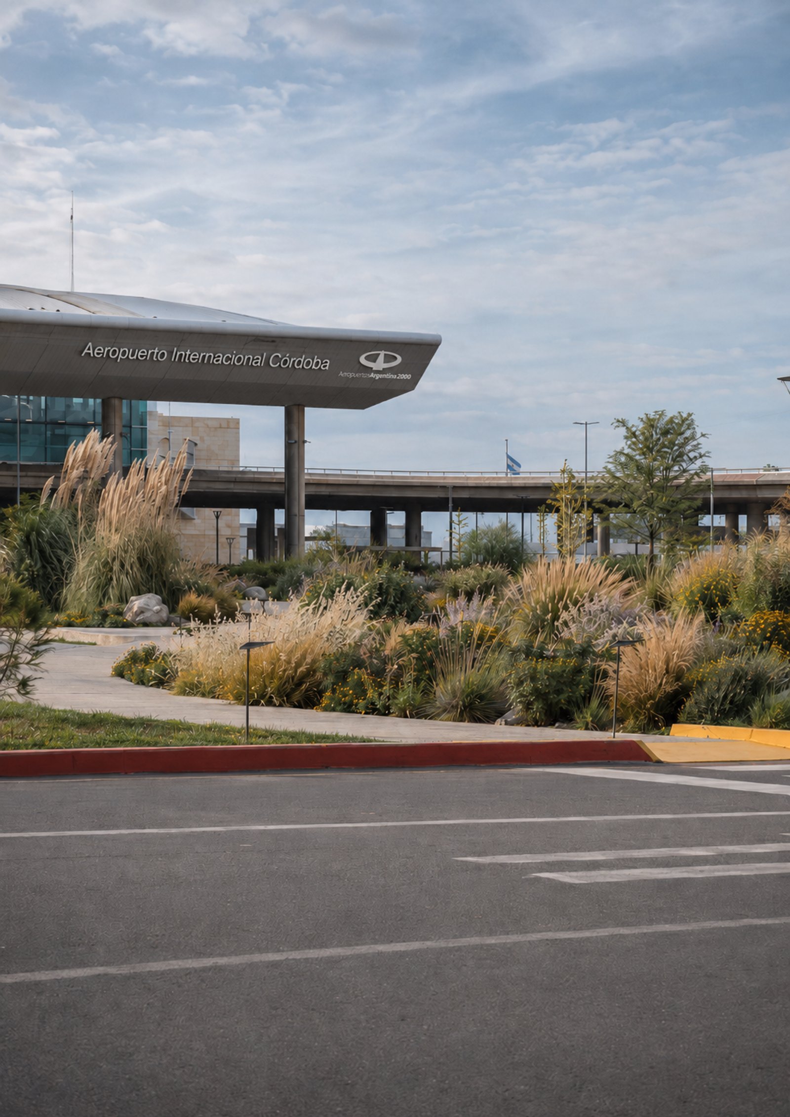 Fachada de aeropuerto moderno con vegetación exuberante — proyecto Aeropuerto Internacional Ing. Taravella :: Córdoba :: Paisajismo Institucional :, por STIPA Arte Natural, en Av. 